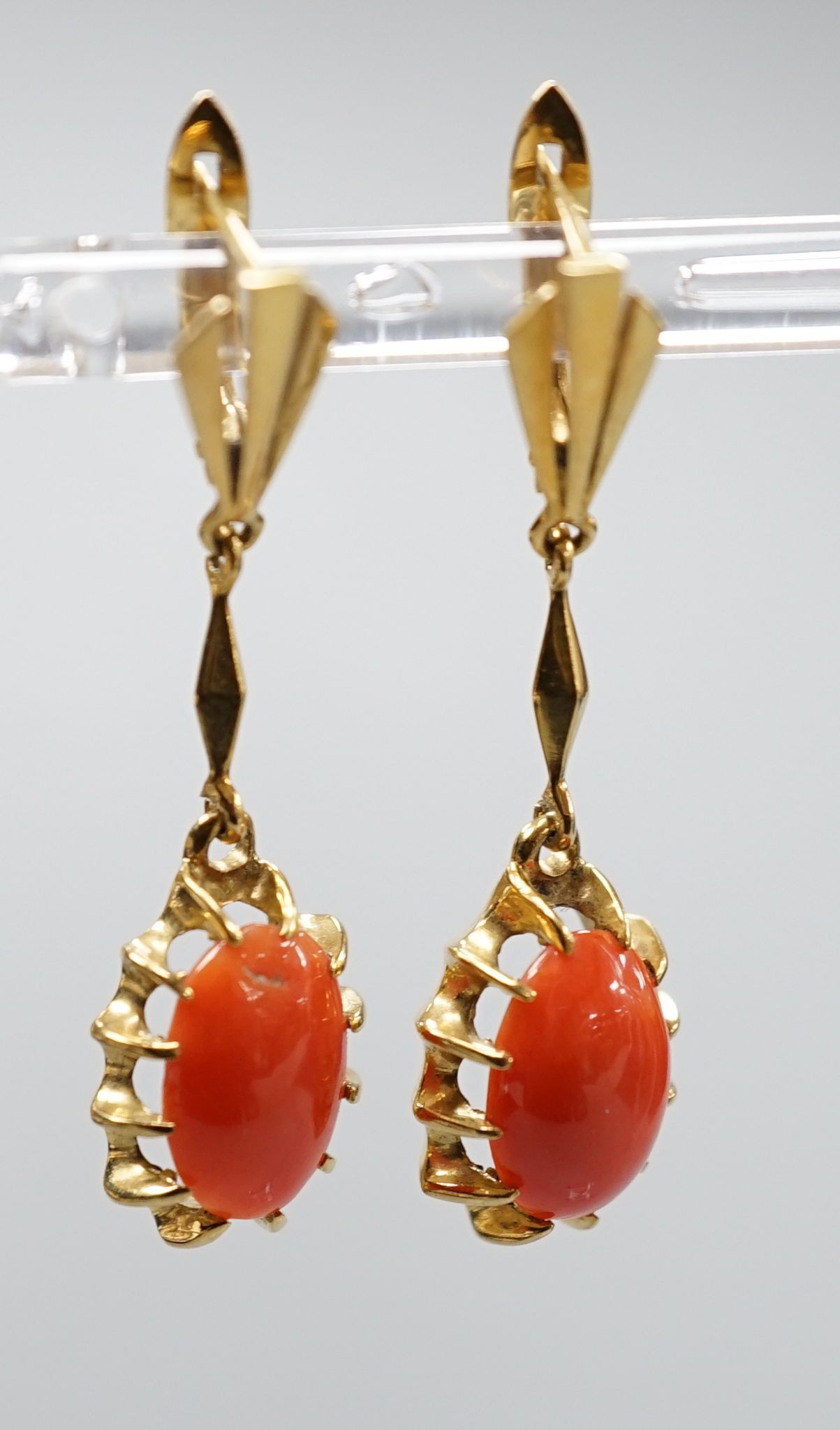 A pair of 18k and oval coral bead set drop earrings, 39mm, gross weight 6.8 grams.